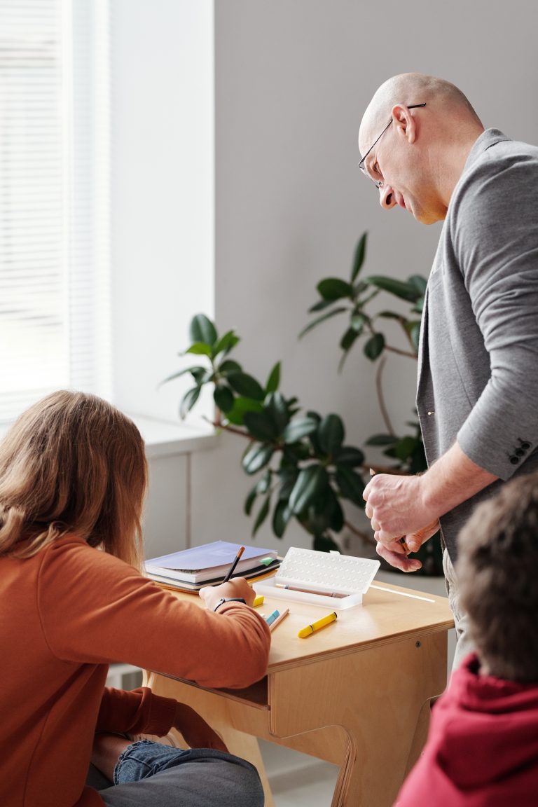 Christian school teacher speaking to child