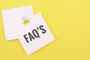 Note written on a white sticker with paper clip. FAQ’s. Frequently Asked Question