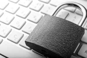 Padlock lying on the computer-keyboard
