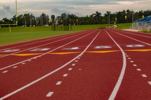 A closeup of a red high school track and a field